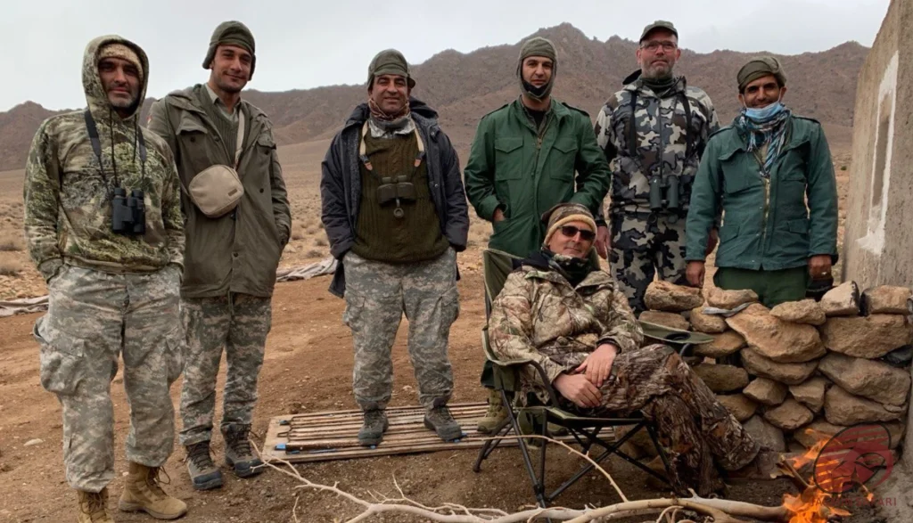 Group of hunters at a desert mountain camp in Iran near a campfire, hunt in Iran