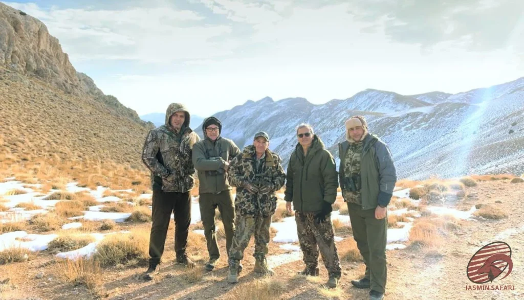 Group of hunters posing in Iran’s snowy highlands during a winter expedition, hunt in Iran
