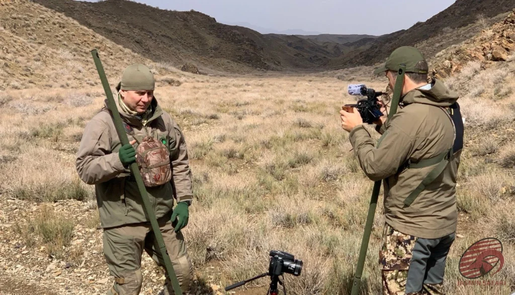 Hunters filming field notes with cameras in an Iranian steppe valley, hunt in Iran