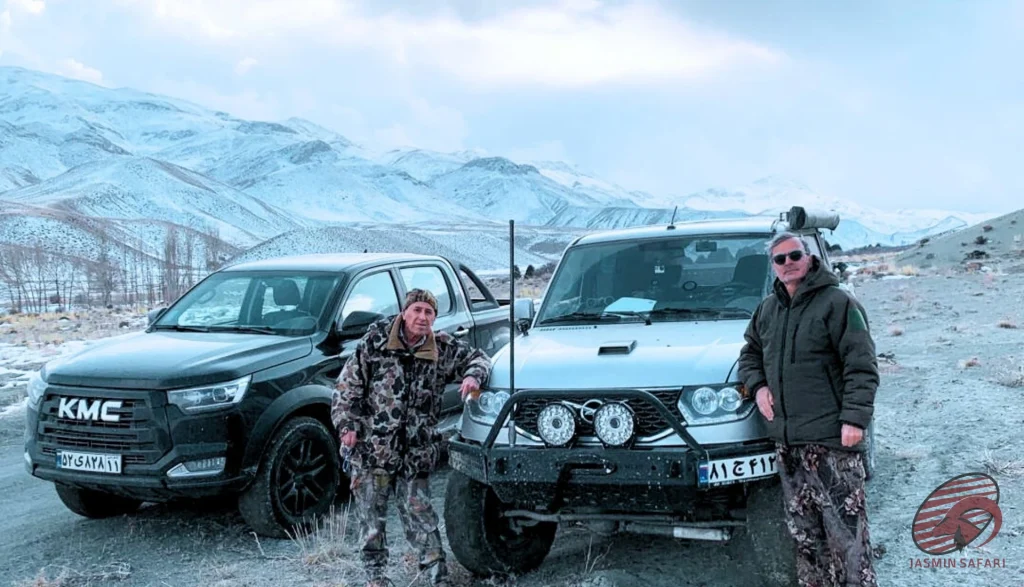 Hunters with two 4×4 vehicles in front of snowy mountains in Iran, hunt in Iran